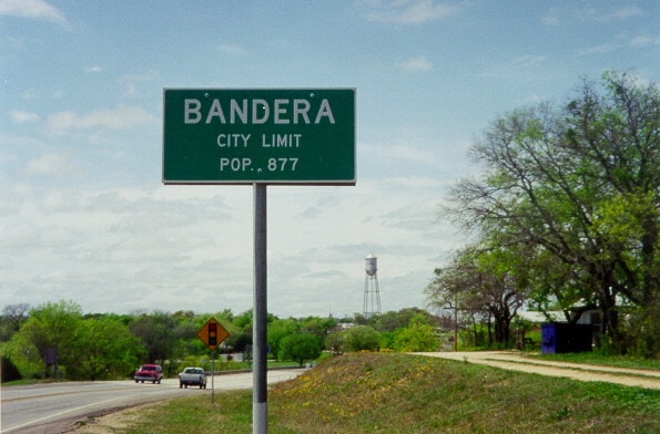 Bandera AC Company - Bandera, TX city limit road sign. Population 877.